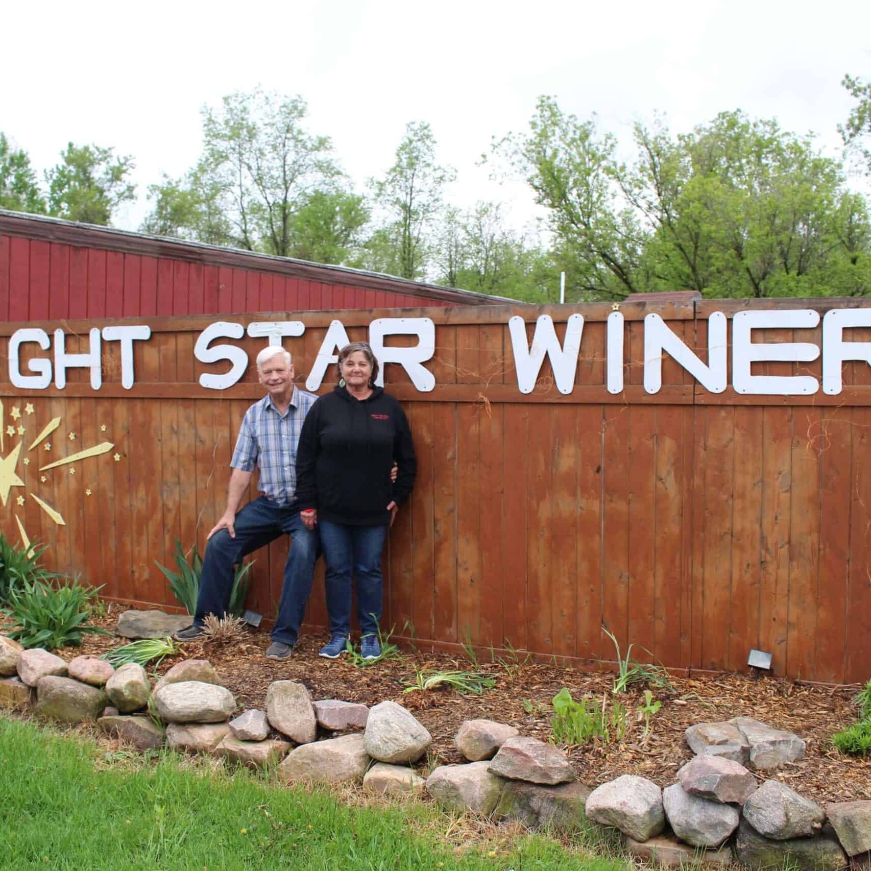 Photo of owners, Marcy and Jerry Bright, standing outside the winery.